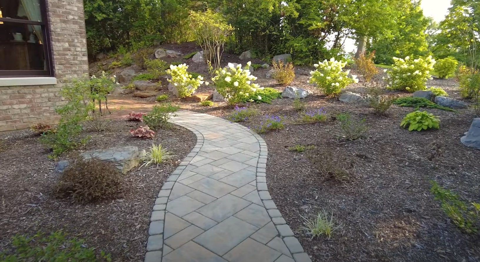 Clean landscape edging and defined borders creating polished outdoor spaces Professional landscape with defined borders and neat edging around garden beds