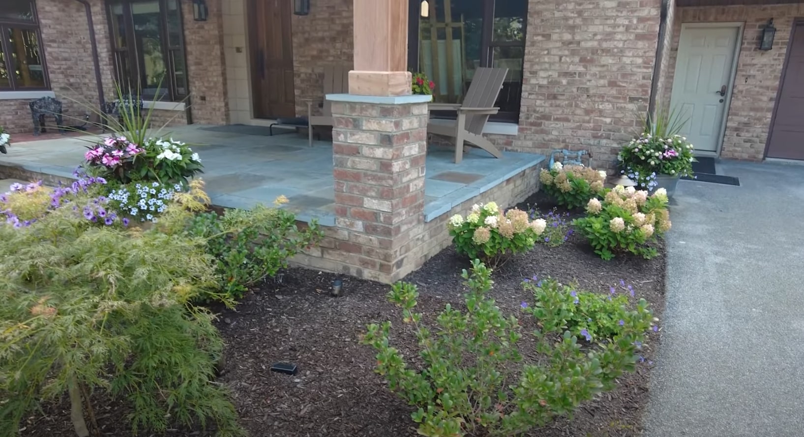 Award-winning landscaping design featuring colorful plantings and brick hardscaping Professional landscaping with beautiful flower beds and hardscaping in La Porte, TX